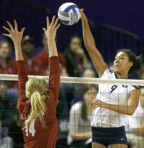 Rick Egan  | The Salt Lake Tribune 

Alexa Gray spikes the ball as Sallie McLaurin defends for Oklahoma, as BYU faced Oklahoma in NCAA  volleyball action at the Smith Fieldhouse in Provo, Saturday, December 1, 2012.