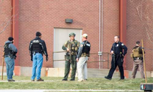 Rick Egan  |  The Salt Lake Tribune

Police officers stand guard outside Pleasant Grove High school, where a student reported seeing someone with a weapon, Thursday, December 3, 2015.