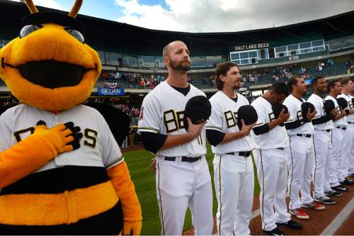 Scott Sommerdorf   |  The Salt Lake Tribune
Bees players and "Bumble" the mascot, at attention during the national anthem prior to the Bees home opener. The Salt Lake Bees opened their 2015 season against the Sacramento River Cats at Smith's Ballpark, Friday, April 17, 2015.