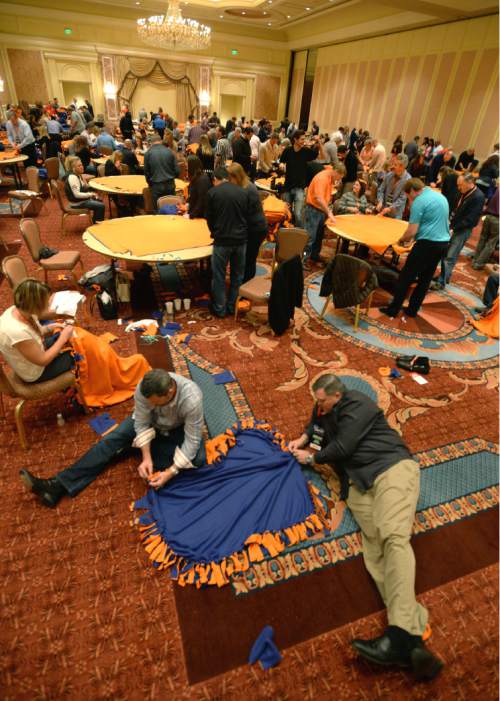 Steve Griffin  |  The Salt Lake Tribune

250 Academy Mortgage managers from across the United States, in conjunction with the company's annual Leadership Summit, work together to make more than 1,000 fleece blankets from 2,500 pounds of fabric for patients at Primary Children's Hospital. They also wrapped over 600 Christmas presents for 25 refugee families who are now living in Salt Lake City. The gifts were all donated by Academy employees and include couches, washing machines and dryers, televisions, DVD players and bikes. The group made the blankets in a ballroom at the Grand America in Salt Lake City, Wednesday, December 2, 2015.