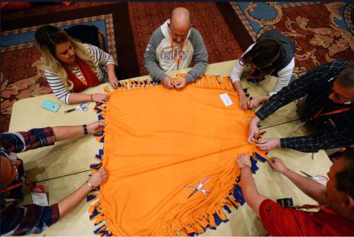 Steve Griffin  |  The Salt Lake Tribune

250 Academy Mortgage managers from across the United States, in conjunction with the company's annual Leadership Summit, work together to make more than 1,000 fleece blankets from 2,500 pounds of fabric for patients at Primary Children's Hospital. They also wrapped over 600 Christmas presents for 25 refugee families who are now living in Salt Lake City. The gifts were all donated by Academy employees and include couches, washing machines and dryers, televisions, DVD players and bikes. The group made the blankets in a ballroom at the Grand America in Salt Lake City, Wednesday, December 2, 2015.