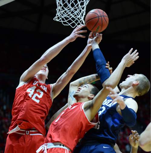 Steve Griffin  |  The Salt Lake Tribune

Utah Utes forward Jakob Poeltl (42) and Utah Utes forward Brekkott Chapman (0) battle for a rebound with Brigham Young Cougars forward Nate Austin (33) during first half action in the Utah versus BYU men's basketball game at the Huntsman Center in Salt Lake City, Wednesday, December 2, 2015.