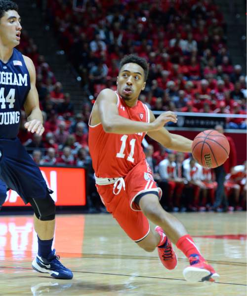 Steve Griffin  |  The Salt Lake Tribune

dUtah Utes guard Brandon Taylor (11) drives past Brigham Young Cougars center Corbin Kaufusi (44) during first half action in the Utah versus BYU men's basketball game at the Huntsman Center in Salt Lake City, Wednesday, December 2, 2015.