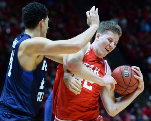 Steve Griffin  |  The Salt Lake Tribune

Brigham Young Cougars center Corbin Kaufusi (44) fouls  Utah Utes forward Jakob Poeltl (42 )during first half action in the Utah versus BYU men's basketball game at the Huntsman Center in Salt Lake City, Wednesday, December 2, 2015.