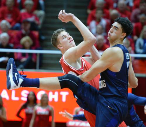 Steve Griffin  |  The Salt Lake Tribune

Utah Utes forward Jakob Poeltl (42) and Brigham Young Cougars center Corbin Kaufusi (44) crash together during first half action in the Utah versus BYU men's basketball game at the Huntsman Center in Salt Lake City, Wednesday, December 2, 2015.