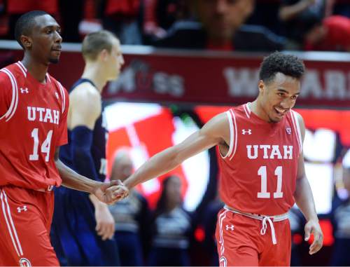 Steve Griffin  |  The Salt Lake Tribune

Utah Utes guard Brandon Taylor (11) smiles as he slaps hands with Utah Utes forward Dakarai Tucker (14) after he was fouled late in the second half action in the Utah versus BYU men's basketball game at the Huntsman Center in Salt Lake City, Wednesday, December 2, 2015.