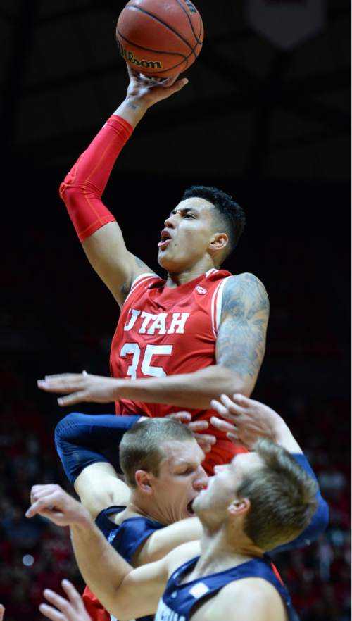 Steve Griffin  |  The Salt Lake Tribune

Utah Utes forward Kyle Kuzma (35) soars above the BYU defense as he scores a basket during first half action in the Utah versus BYU men's basketball game at the Huntsman Center in Salt Lake City, Wednesday, December 2, 2015.