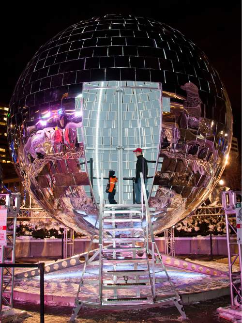 Michael Mangum  |  Special to the Tribune

Spectators roam the inner workings of the giant mirror ball at the first night of EVE at the Salt Palace Convention Center in Salt Lake City on Monday, December 29, 2014.