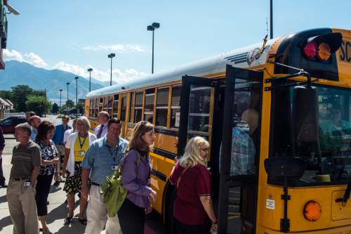 Chris Detrick  |  The Salt Lake Tribune
Principals and assistant principals from schools in Riverton and Bluffdale get onto a bus outside of Peterson's Fresh Market during a tour of Riverton Wednesday August 6, 2014. The Jordan School District organized a bus tour for its principals and assistant principals to learn more about the cities in its boundaries.