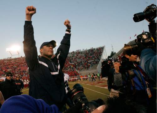 Rick Egan  |  Tribune File Photo

Bronco Mendenhall celebrates the Cougar win as he leaves the field at Rice-Eccles Stadium in 2006.