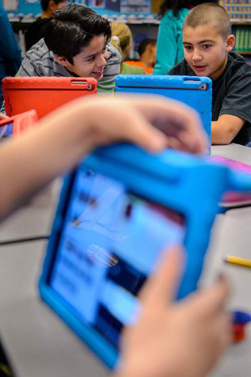 Trent Nelson  |  The Salt Lake Tribune
Newman Elementary fifth-graders Adam Rodriguez and Jerry Valdez work on a class project on an iPad, in Salt Lake City, Tuesday November 17, 2015. The project was meant to answer the question of magnets, how do they work?