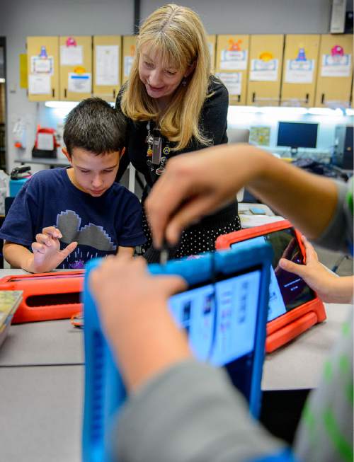 Trent Nelson  |  The Salt Lake Tribune
Newman Elementary fifth-grader Eddie Adams gets help from teacher Angelique Morrill while working on a class project on an iPad, in Salt Lake City, Tuesday November 17, 2015. The project was meant to answer the question of magnets, how do they work?