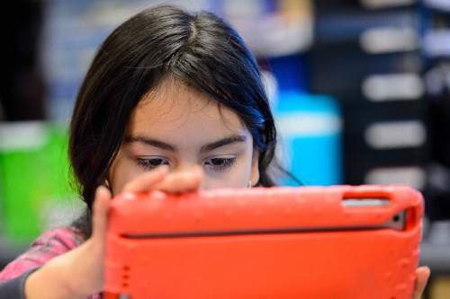 Trent Nelson  |  The Salt Lake Tribune
Newman Elementary fifth-grader Sofia Flores works on a class project on an iPad, in Salt Lake City, Tuesday November 17, 2015. The project was meant to answer the question of magnets, how do they work?