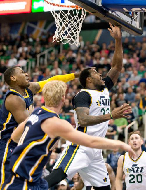 Lennie Mahler  |  The Salt Lake Tribune

Trevor Booker puts up a shot past Indiana Pacers Chase Budinger and Lavoy Allen in the first half of an NBA basketball game at Vivint Smart Home Arena on Saturday, Dec. 5, 2015.