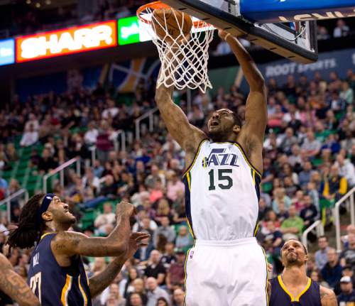 Lennie Mahler  |  The Salt Lake Tribune

Derrick Favors dunks over Indiana Pacers Jordan Hill and George Hill in the first half of an NBA basketball game at Vivint Smart Home Arena on Saturday, Dec. 5, 2015.