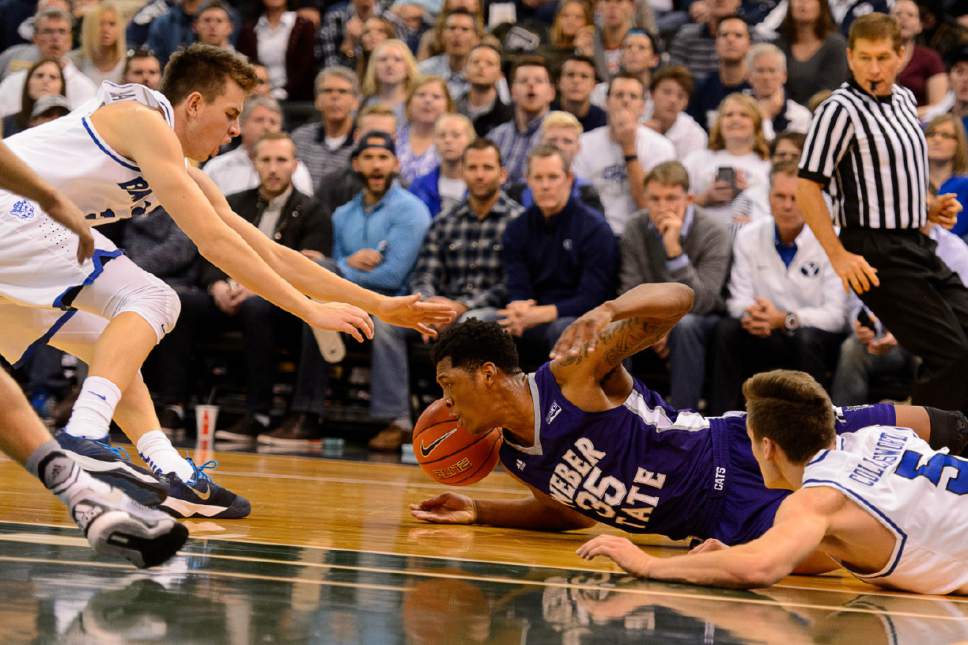 Trent Nelson  |  The Salt Lake Tribune
BYU's Zac Seljaas and Weber State's Kyndahl Hill dive for a loose ball as BYU faces Weber State, NCAA basketball at Vivant Smart Home Arena in Salt Lake City, Saturday December 5, 2015.
