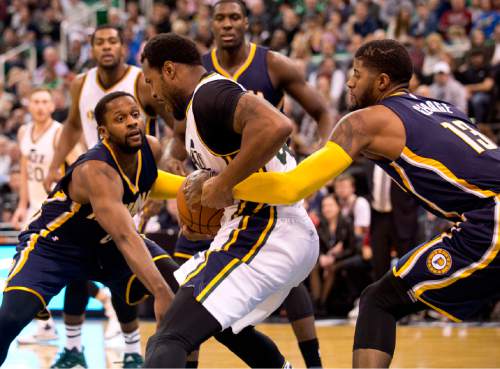 Lennie Mahler  |  The Salt Lake Tribune

Trevor Booker secures a loose ball as he is guarded by C.J. Miles and Paul George in the first half of an NBA basketball game at Vivint Smart Home Arena on Saturday, Dec. 5, 2015.