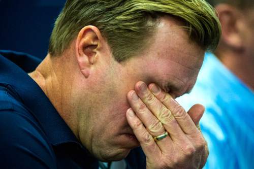 Chris Detrick  |  The Salt Lake Tribune
Cougar football head coach Bronco Mendenhall wipes away a tear during a press conference at Brigham Young University Friday December 4, 2015.  Mendenhall signed a five-year contract with the University of Virginia that will pay him $3.25 million annually, estimated to be more than three times the money he makes coaching BYU.