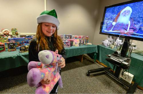 Francisco Kjolseth | The Salt Lake Tribune
Lillian Taylor, 9, of Elko Nevada, who is a patient at Shriners Hospital for Children in Salt Lake pics out a present after having a video chat with Santa Claus from the "North Pole" through the magic of collaboration technology. Much like children who are able to sit on Santaís lap, patients were given the opportunity to interact directly with Santa and pass along their wishes this holiday season. This is an example of how technology can be used to improve lives and bring a little happiness to sick kids during the holidays. Dimension Data provided the video chat technology in Utah and for Shriners Hospitals for Children nationwide.