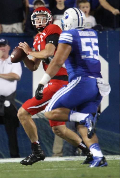 Rick Egan  | The Salt Lake Tribune 

Brigham Young Cougars defensive lineman Eathyn Manumaleuna puts the pressure on Utah Utes quarterback Travis Wilson (7) as BYU faced The University of Utah, at Lavell Edwards Stadium, Saturday, September 21, 2013.