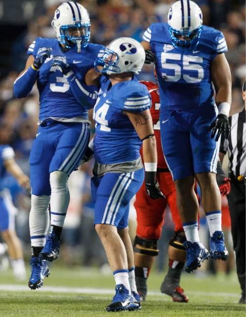 Trent Nelson  |  The Salt Lake Tribune
Brigham Young Cougars defensive lineman Remington Peck (44, center) celebrates his sack of Utah Utes quarterback Travis Wilson (7) with teammates linebacker Kyle Van Noy (3) and Brigham Young Cougars defensive lineman Eathyn Manumaleuna (55) in the first quarter as the BYU Cougars host the Utah Utes, college football Saturday, September 21, 2013 at LaVell Edwards Stadium in Provo.