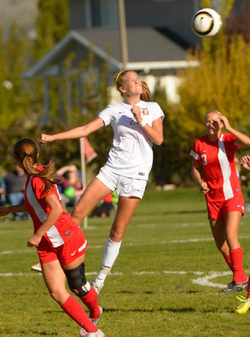 Leah Hogsten  |  The Salt Lake Tribune
Davis' Mikayla Colohan heads the ball to her teammate.   Davis High School girls soccer team defeated American Fork, Thursday, October 15, 2015.