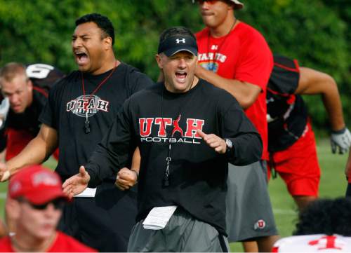 UTAH FOOTBALL 
Utah head coach Kyle Whittingham (center) and defensive coordinator Kalani Sitake (left) yell as they have the team break up into smaller units to begin drills, Thursday, 8/06/09.
Scott Sommerdorf  / The Salt Lake Tribune