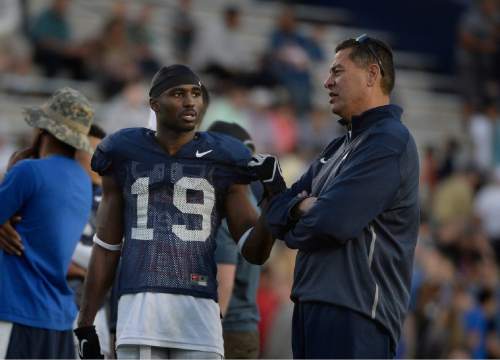 Scott Sommerdorf   |  The Salt Lake Tribune
BYU WR Devon Blackmon talks with offensive coordinator Robert Anae as BYU football had it's first scrimmage, Friday, March 27, 2015.