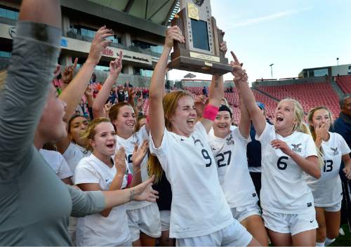 Scott Sommerdorf   |  The Salt Lake Tribune
Skyline's Holly Daugirda (9), raises the 4A trophy as her team mates celebrate after Skyline beat Timpanogos 3-1 for the girl's 4A soccer title 3-1 played at Rio Tinto stadium, Friday, October 23, 2015.