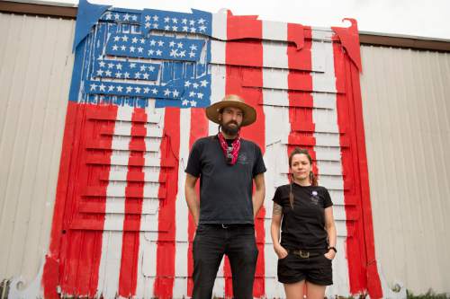 Jeremy Harmon  |  The Salt Lake Tribune

IATSE (International Alliance of Theatrical Stage Employees) members Josh and Heidi Belka stand outside the IATSE union building in Salt Lake City on Wednesday, July 22, 2015. Behind them is their mural of labor icon Joe Hill that was painted over with a US flag. The mural was painted over by other members of the union who objected to the murals political tone.