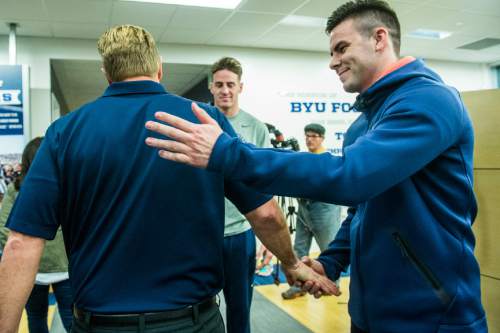 Chris Detrick  |  The Salt Lake Tribune
Tanner Mangum greets Cougar football head coach Bronco Mendenhall as he walks away after a press conference at Brigham Young University Friday December 4, 2015.  Mendenhall signed a five-year contract with the University of Virginia that will pay him $3.25 million annually, estimated to be more than three times the money he makes coaching BYU.