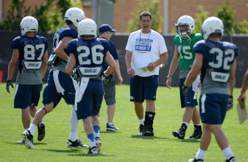 Francisco Kjolseth  |  The Salt Lake Tribune
BYU offensive coordinator Robert Anae, center, runs the team through drills during the first practice of the season.