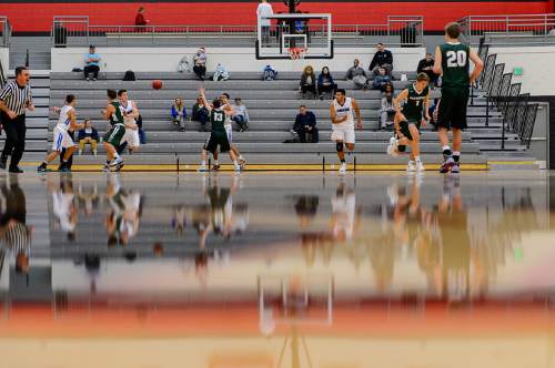 Trent Nelson  |  The Salt Lake Tribune
Reflections on the court as Bingham plays Olympus in the first round of the boys' basketball Elite 8 Tournament at American Fork High School, Thursday December 10, 2015.