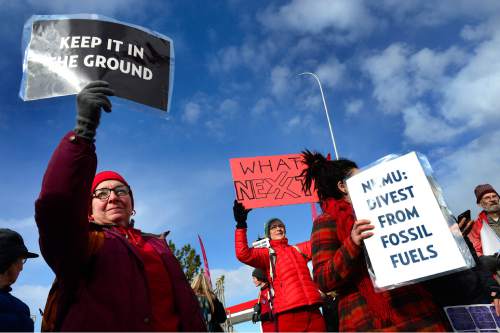 Scott Sommerdorf   |  The Salt Lake Tribune
Environmental activist demonstrators blockaded this Exxon station in Murray with red lines meant to symbolize Exxon's closure, which the activists demand as retribution for the company's alleged role in denying climate change, Saturday, December 12, 2015.