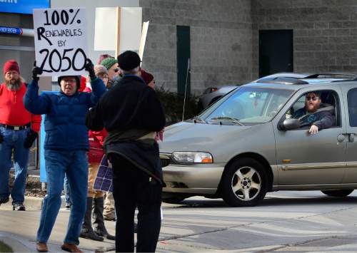 Scott Sommerdorf   |  The Salt Lake Tribune
This motorist in a mini-van became belligerent when he could not enter the Exxon station blockaded by environmental activist demonstrators. They blockaded this Exxon station in Murray with red lines meant to symbolize Exxon's closure, which the activists demand as retribution for the company's alleged role in denying climate change, Saturday, December 12, 2015.