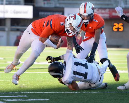 Scott Sommerdorf   |  The Salt Lake Tribune
Timpview QB Kahi Neves runs the ball near there Highland goal line as Highland's Nathan Roderick makes the TD saving tackle during first half play. Timpview led Highland 21-19 at the half in a 4A semi-final game played at Rice-Eccles stadium, Thursday, November 12, 2015.