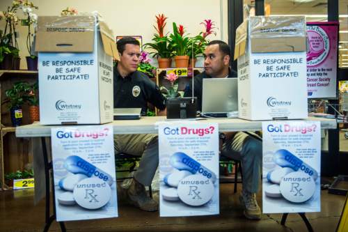 Chris Detrick  |  The Salt Lake Tribune
West Valley City Detectives Scott Arnold, left, and Tony Wolfgramm collect unused prescription drugs at Smith's Food and Drug in West Valley City Saturday September 27, 2014. Utahns who wanted to get rid of unwanted, expired and unused prescription drugs could drop them off Saturday at 12 Smith's Food and Drug stores in Utah, Salt Lake and Davis counties.  Smith's is teaming with the Drug Enforcement Administration to collect the medications, no questions asked, between 10 a.m. and 2 p.m.