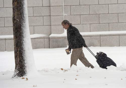 Al Hartmann  |  The Salt Lake Tribune
Monday morning  was a nightmare for those commuting to work by car in Salt Lake City as the snow falls Monday morning Dec. 14.  It wasn't easy for those on foot either.