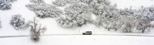 Steve Griffin  |  The Salt Lake Tribune

An car navigates the snow covered road in City Creek Canyon as a major storm dumped snow through out the sate in Salt Lake City, Monday, December 14, 2015.