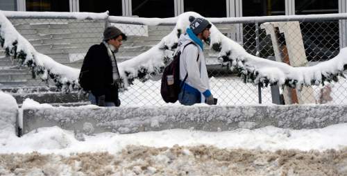 Al Hartmann  |  The Salt Lake Tribune
Folks go back to work making their way on pedestrian walkway construction site at 100 South and Main St. in Salt Lake City as the city digs out from yesterday's record breaking snowfall Tuesday Dec. 15.