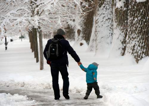 Al Hartmann  |  The Salt Lake Tribune
Father and son explore the beauty of yesterday's record breaking snowfall in Liberty Park as snow hung heavy from branches Tuesday morning Dec. 15.