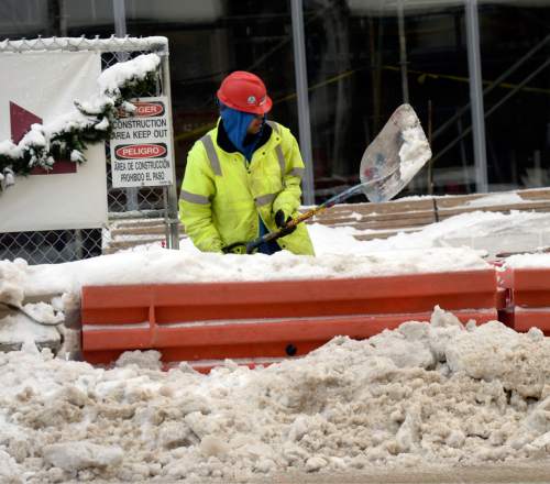 Al Hartmann  |  The Salt Lake Tribune
Construction worker tries to keep work area and pedestrian way clear of snow at 100 South and Main St. in Salt Lake City as the city digs out from yesterday's record breaking snowfall Tuesday Dec. 15.