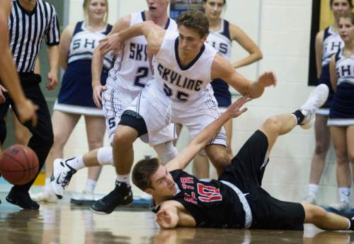 Steve Griffin  |  The Salt Lake Tribune

Skyline's Zack Boudreaux, top, tries to get around Alta's Dylan Kirkland as he dives for the ball during game at Skyline High School in Salt Lake City, Tuesday, December 15, 2015.