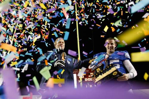 Brigham Young's Max Hall #15 and Bronco Mendenhall celebrate after the Las Vegas Bowl at Sam Boyd Stadium Tuesday December 22, 2009.  BYU defeated Oregon State 44-20.
Photo by Chris Detrick | The Salt Lake Tribune