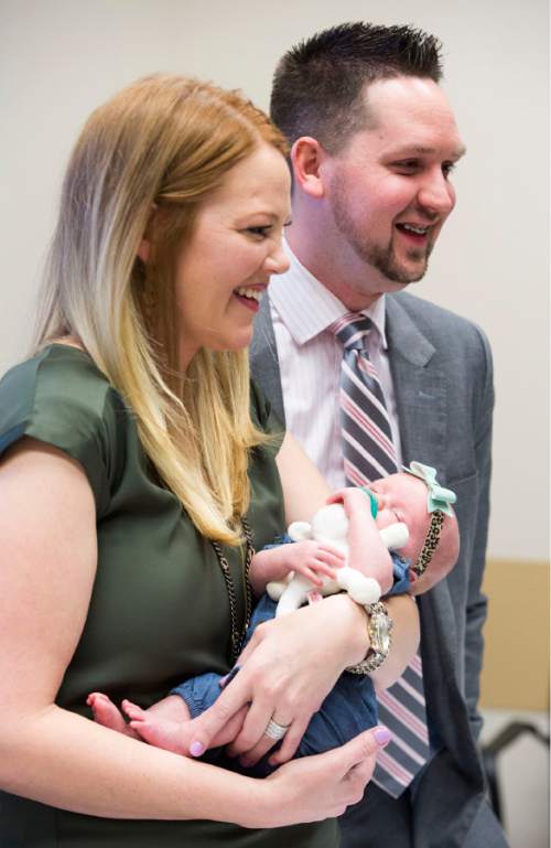 Rick Egan  |  The Salt Lake Tribune

 Arlee and Ryan Gregerson, smile as they hold their baby Lucy, at the Intermountain Medical Center.  When Lucy was two days old, Arlee Gregerson nearly died, but thanks to the swift action and life-saving coordination of medical teams at Intermountain Medical Center in Murray, Arlee and her baby are both doing well. They returned to the hospital to reunite with the doctors and nurses who saved her life one month ago. Thursday, December 17, 2015.