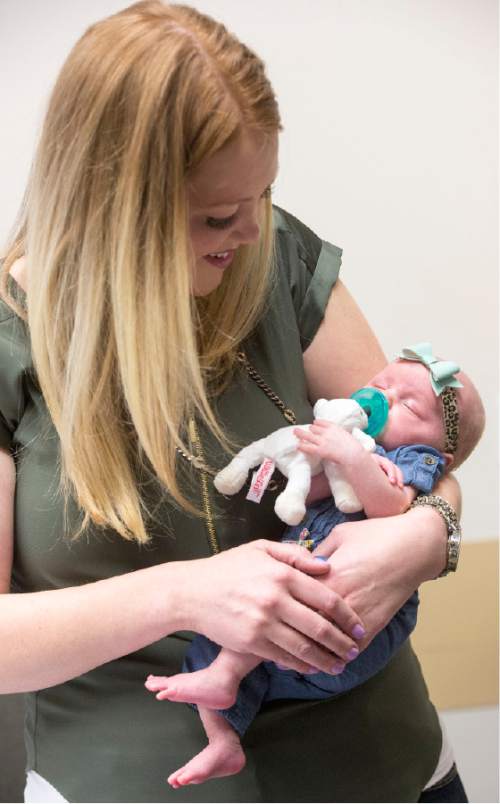 Rick Egan  |  The Salt Lake Tribune

Arlee Gregerson holds baby Lucy at the Intermountain Medical Center.  When Lucy was two days old, Arlee Gregerson nearly died, but thanks to the swift action and life-saving coordination of medical teams at Intermountain Medical Center in Murray, Arlee and her baby are both doing well. They returned to the hospital to reunite with the doctors and nurses who saved her life one month ago. Thursday, December 17, 2015.
