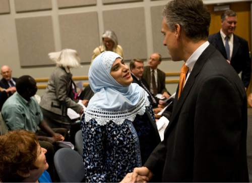 Rivka Levy, (lower left), shakes Governor Jon Huntsman's hand as Ms. Noor Ul-Hasan with the Islamic Society of Greater Salt Lake greets Governor Jon Huntsman Jr. at the State Capitol Administrative Office Thursday for the announcment of the creation of the Refugee Services Office.  Gov. Jon Huntsman Jr.,  Salt Lake County Mayor Peter Carroon, and Palmer DePaulis, Executive Director of Community and Culture made the announcement.  .    Al Hartmann/Salt Lake Tribune    11/8/07