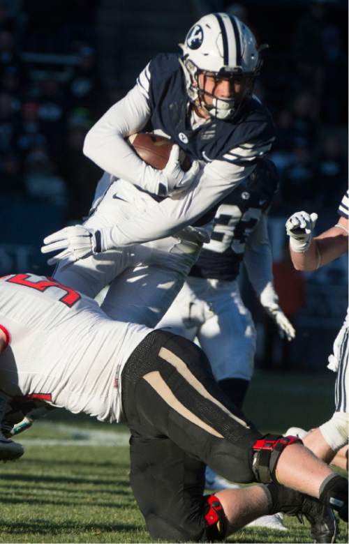 Rick Egan  |  The Salt Lake Tribune

Brigham Young Cougars defensive back Kai Nacua (12) is brought down by Fresno State Bulldogs offensive lineman Justin Northern (54), after intercepting a Bullldog pass,  as BYU defeated the The Fresno Bulldogs 52 -10, at Lavell Edwards stadium, Tuesday, November 21, 2015.