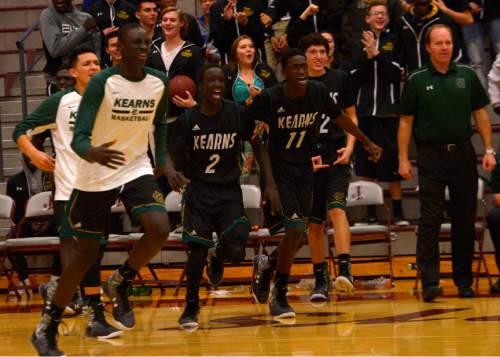 Leah Hogsten  |  The Salt Lake Tribune
The Kearns bench runs to congratulate teammate Mike Hernandez who fired off at 3-point bucket to tie up the game with 15 seconds left. Jordan High School boys basketball team defeated Kearns High School 67-63 in their non-region basketball game, Friday, December 18, 2015.