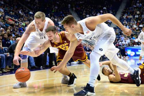 Scott Sommerdorf   |  The Salt Lake Tribune
Central Michigan Chippewas guard Josh Kozinski (12) dives for a loose ball between Brigham Young Cougars forward Kyle Davis (21), left, and Brigham Young Cougars guard Kyle Collinsworth (5). Central Michigan was tied with BYU 44-44 at the half, Friday, December 18, 2015.